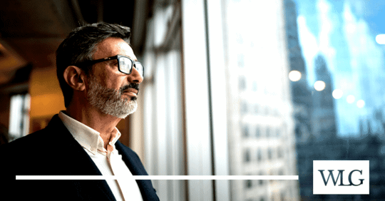 man looking out window